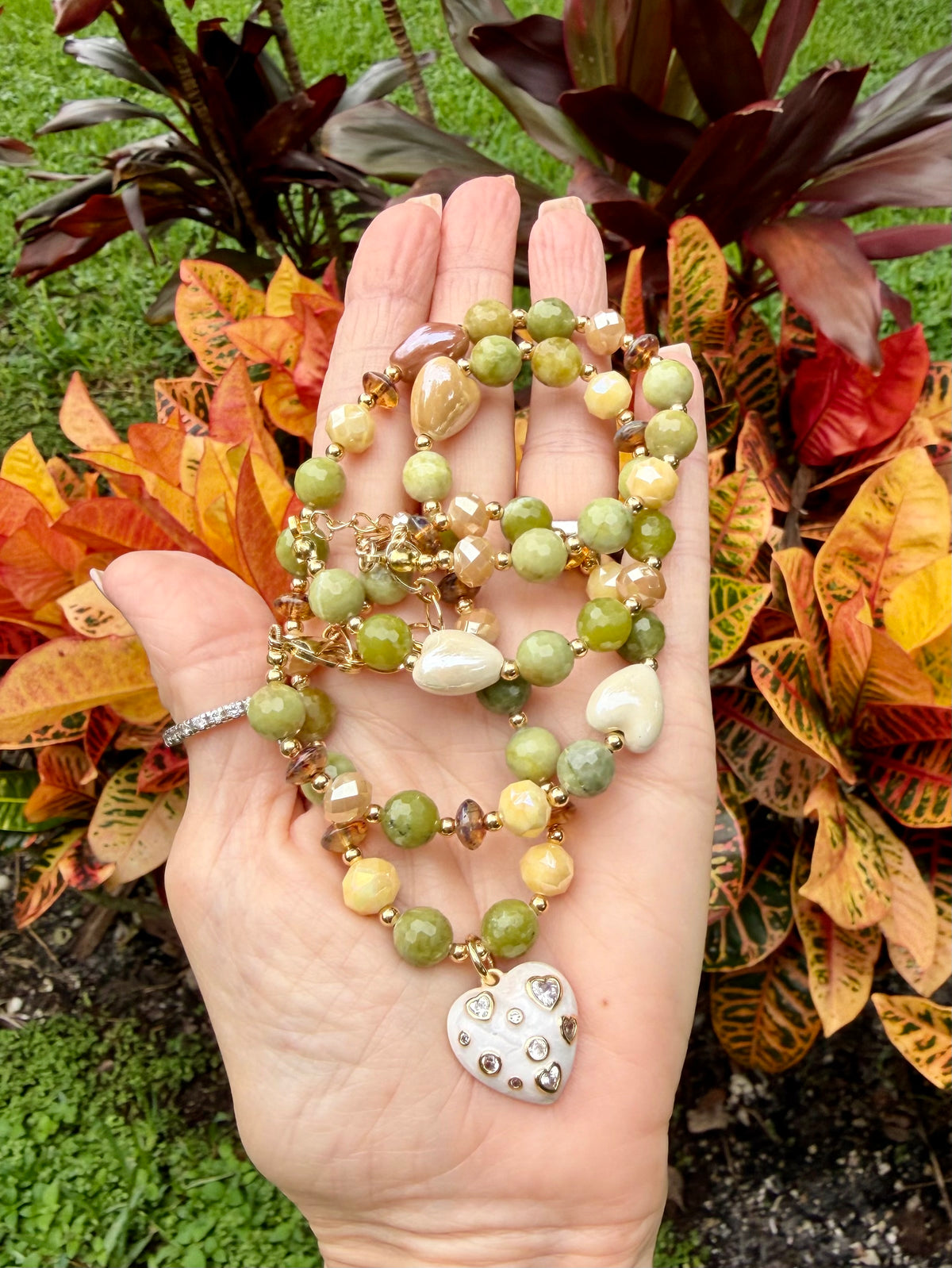Faceted green jade bracelet with white ceramic heart