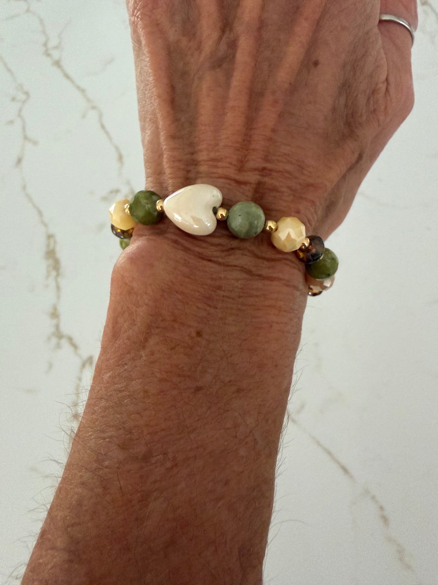 Faceted green jade bracelet with white ceramic heart