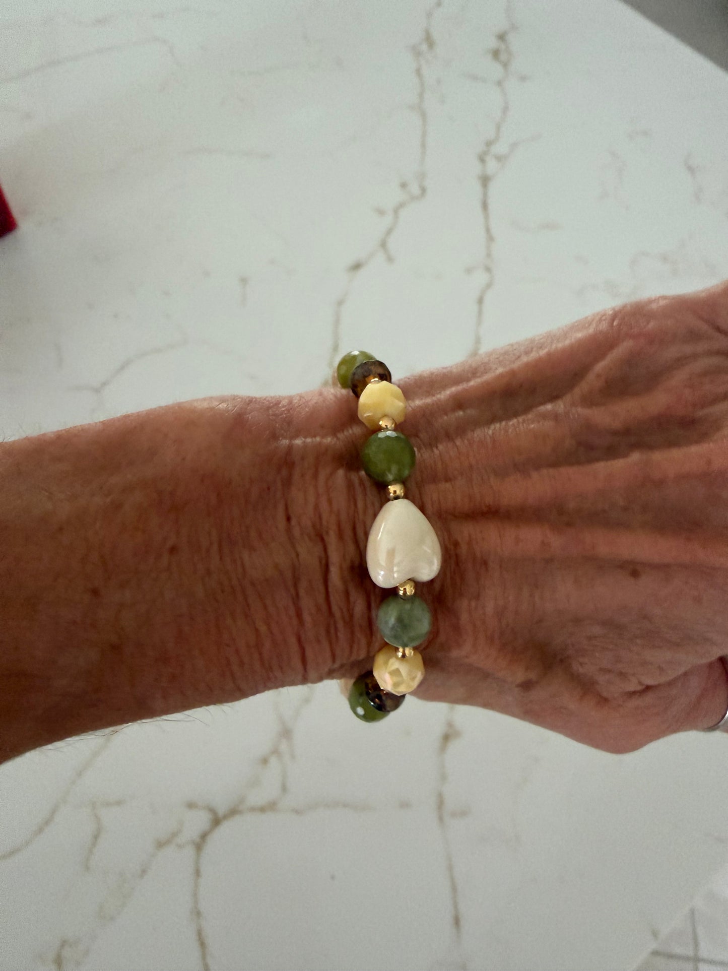 Faceted green jade bracelet with white ceramic heart
